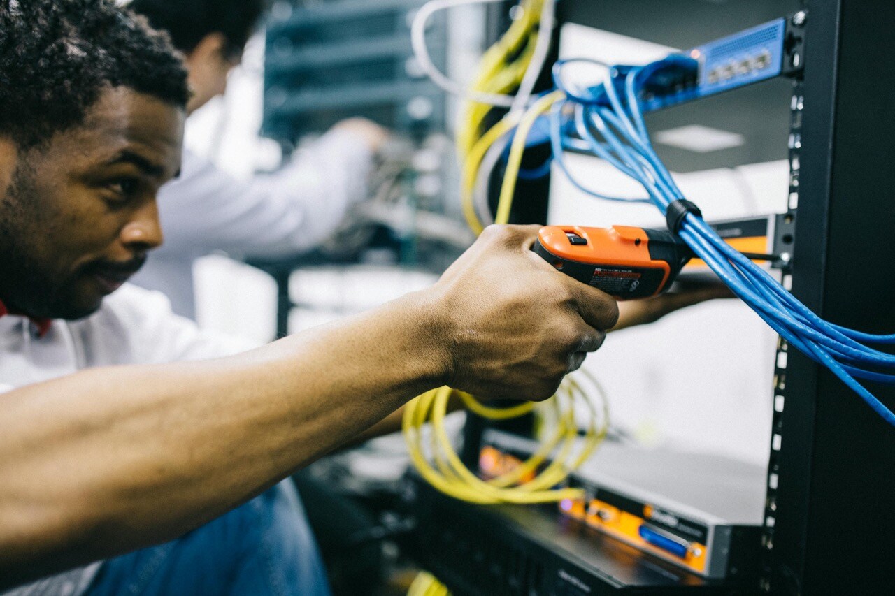 retail technology technician working on cables